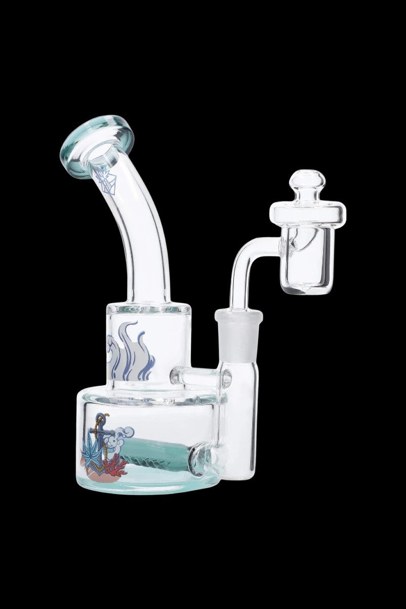 Angled front view of the Cabana Cannabis Co. Ahoy Dab Rig - Teal showing clear glass, curved neck, and nautical decal on the base.