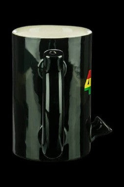 Dark green glass water pipe with a patterned design and a small sticker.