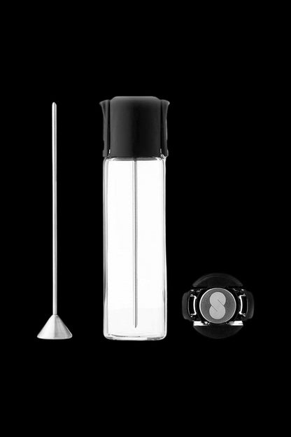 Dab rig oil chamber and loading tool against a black background.