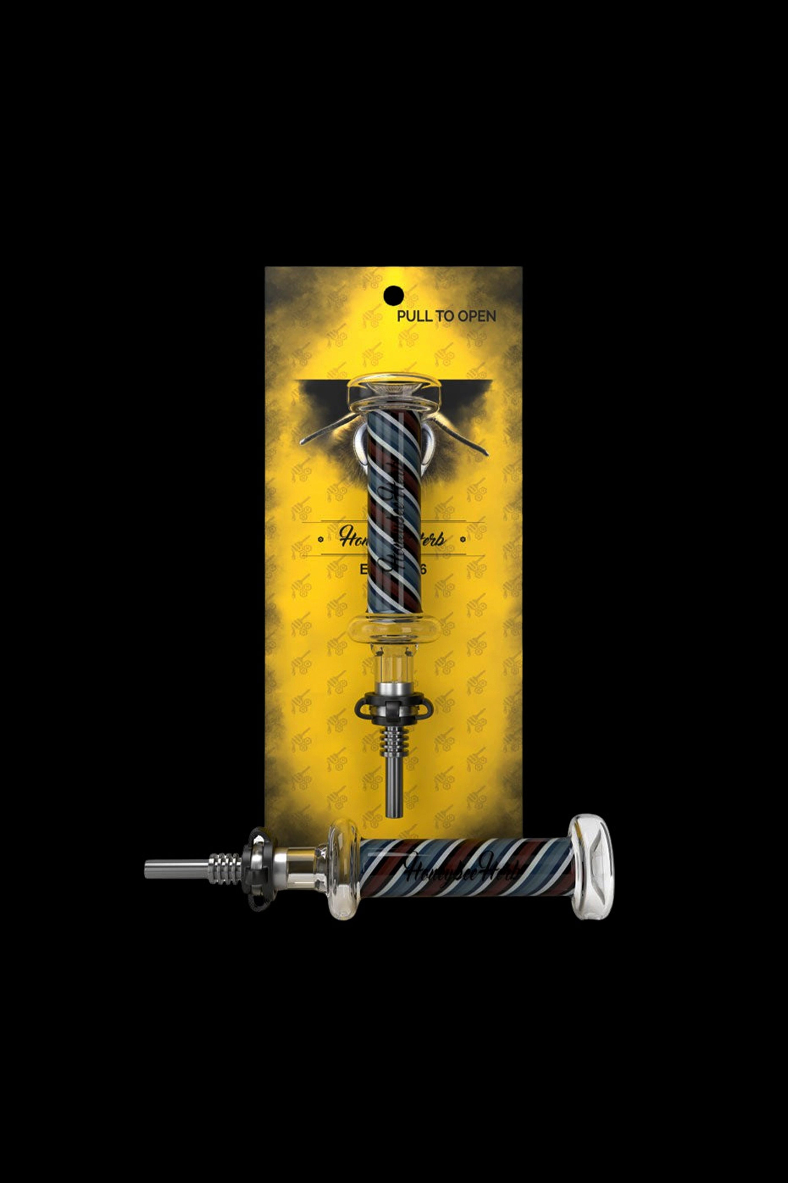 A glass cannabis oil burner pipe in a patterned, resealable bag.