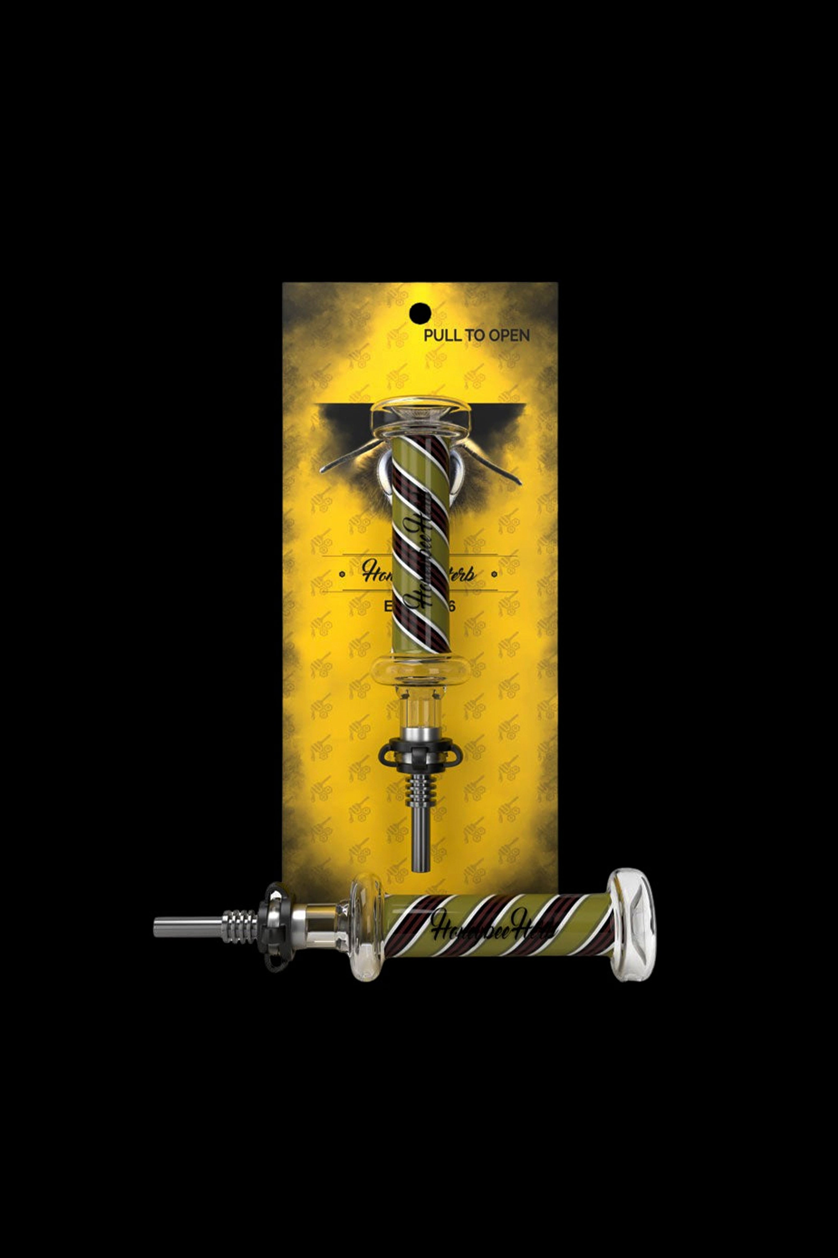 Gold cannabis dab tool with a coiled snake design, displayed in a patterned package.