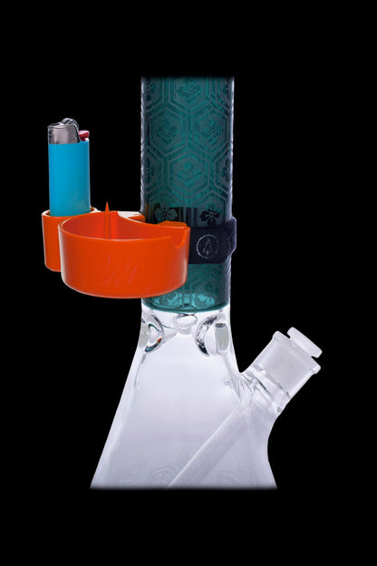 A glass bong with an orange catchall for accessories and a lighter, set against a black background.