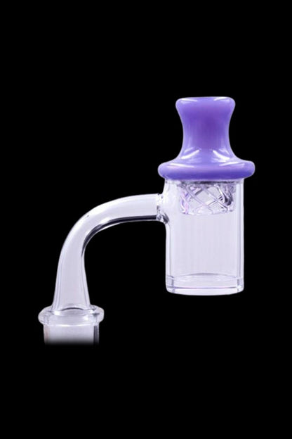 Close-up of The Stash Shack UFO Spinning Carb Cap showing a glossy dark green (appears purple) domed top on a clear glass joint against a black background