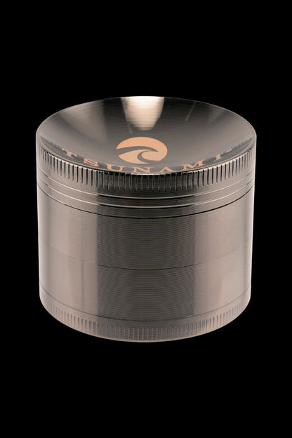 Metal cannabis grinder with textured grip and branded lid.