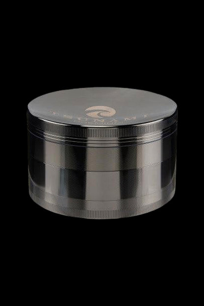 Silver four-piece cannabis grinder on a black background.