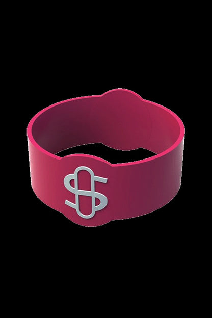 Red silicone ring with a silver dollar sign emblem, likely a cannabis accessory or branding element.