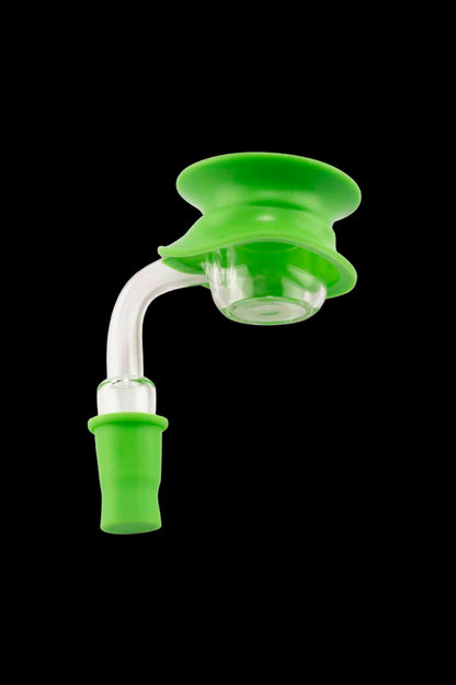 Angled close-up of a bright green Ooze Resolution Caps Cleaning Caps fitted over a glass joint against a black background