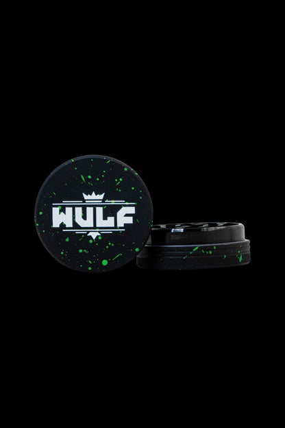 HULP grinder with black and green splatter design on a dark background.