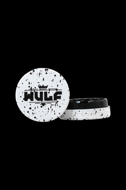 White and black speckled cannabis grinder with "HULF" logo, open to reveal ground herb inside.