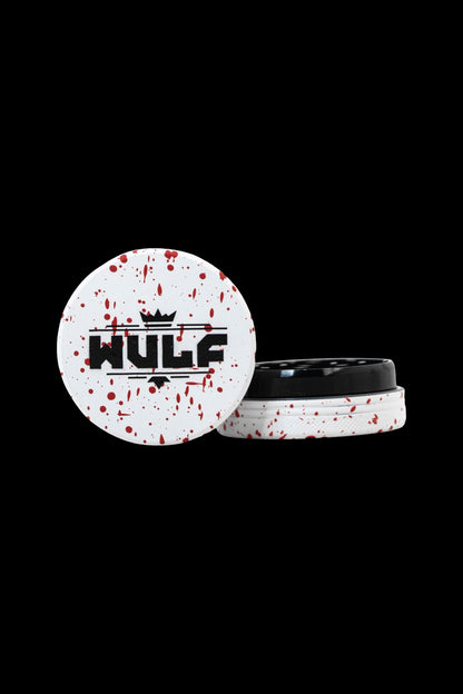 A white and red splattered cannabis concentrate container with “HULF” in bold black lettering and a crown above it.