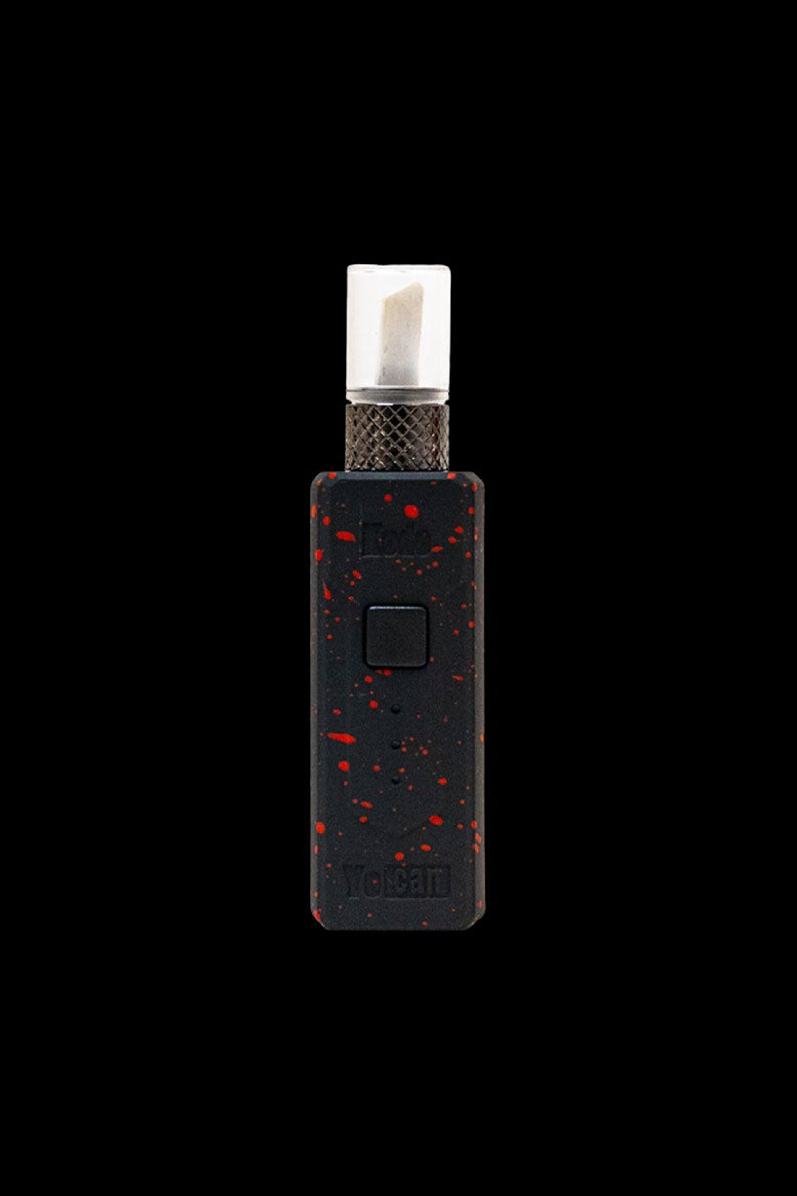 Black and red cannabis dab pen with a white ceramic tip isolated on a black background.