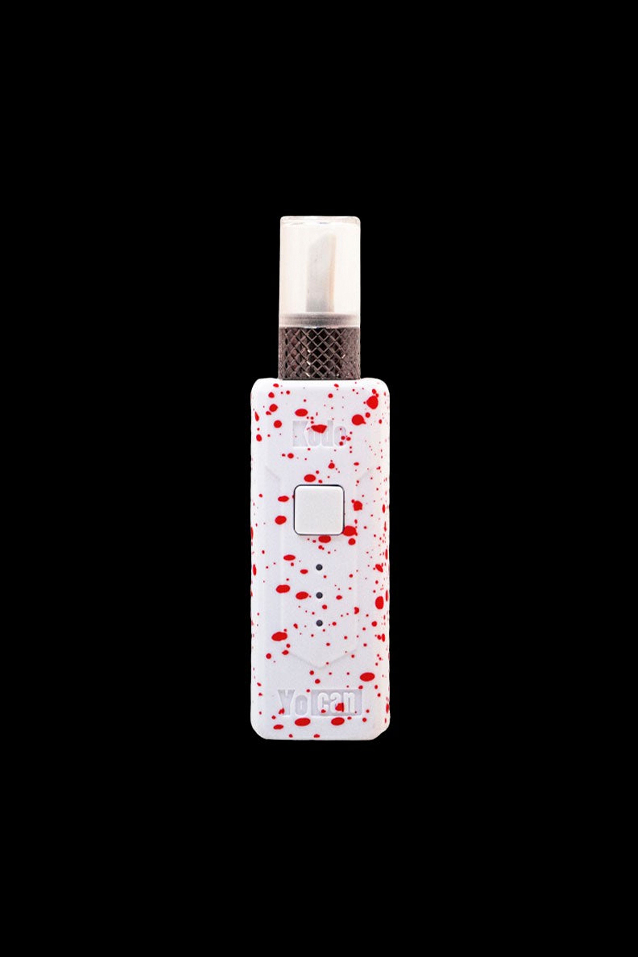 White Yocan cannabis vape pen with red splatter pattern.