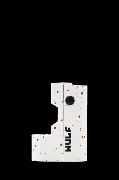White cannabis concentrate vaporizer pen with “Wulf” branding against a black background.