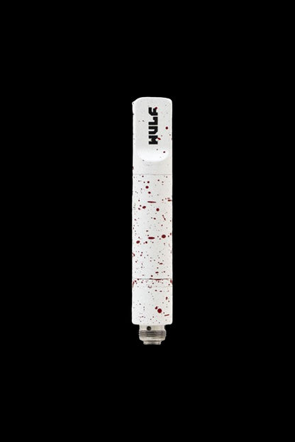 White cannabis oil vape pen with red splatter pattern on black background.