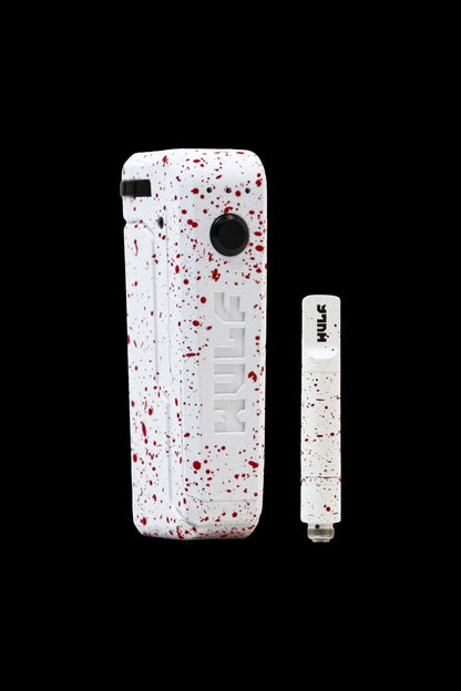 White cannabis vape pen and cartridge with red splatter pattern.