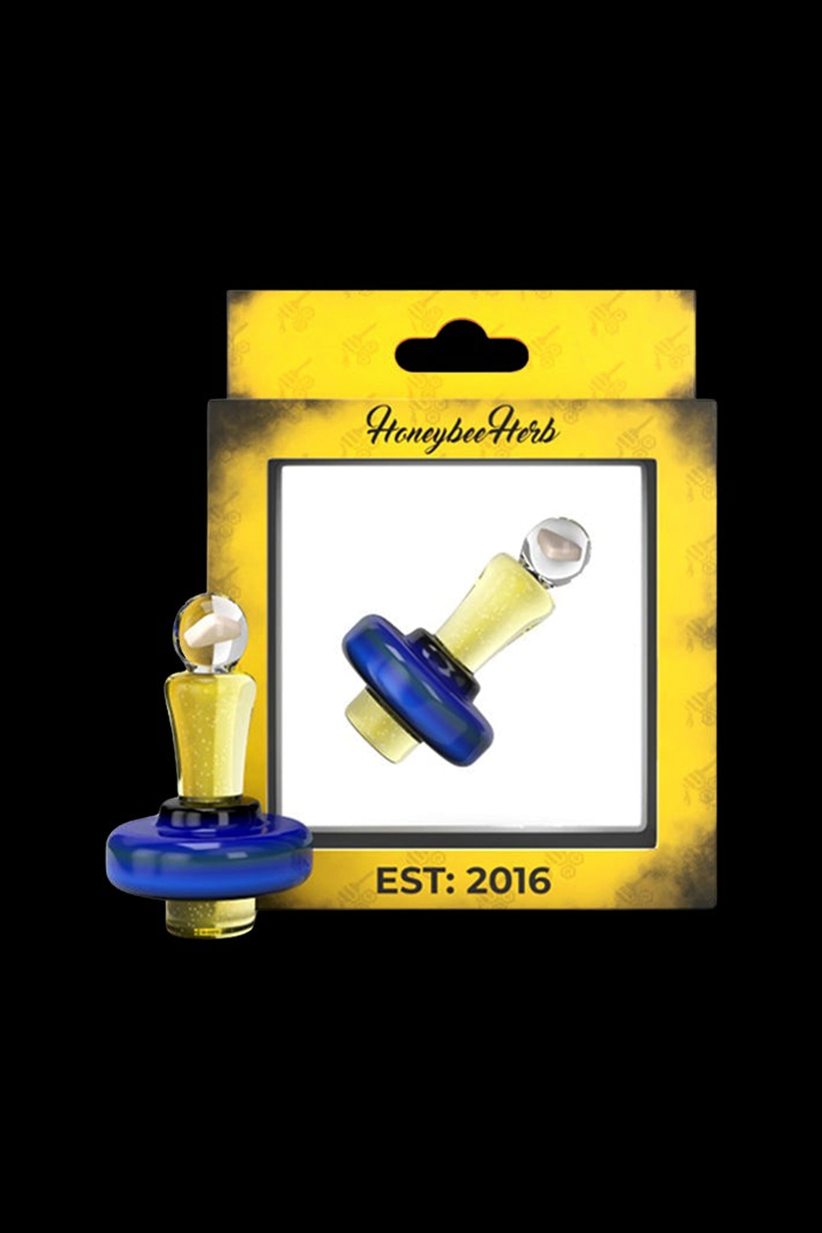 Blue and gold cannabis oil burner with “Honeybee Herb” packaging, established 2016.