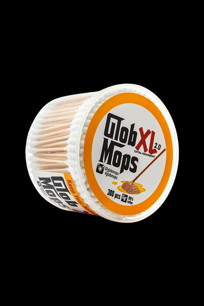 A roll of “Glob Mops” – small, cylindrical cotton swabs used for cleaning cannabis accessories – against a black background.