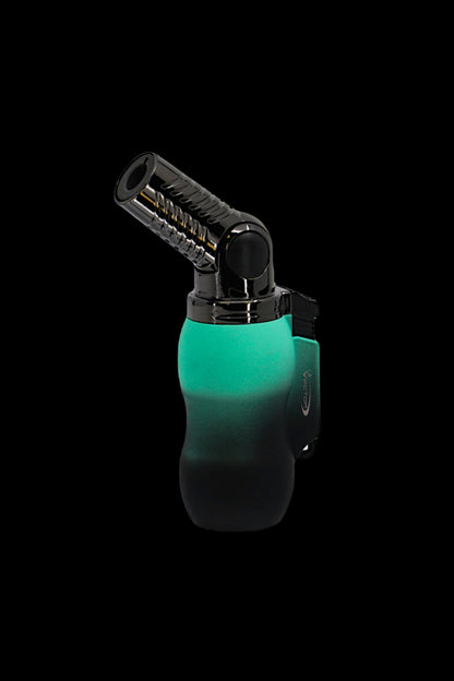 Green and black butane torch lighter isolated on a black background.