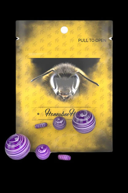 Yellow packaging displaying a bee illustration and purple cannabis dab concentrates.