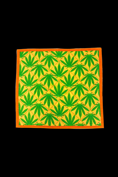 A square patterned bandana featuring repeating green cannabis leaves on a beige background with an orange border.