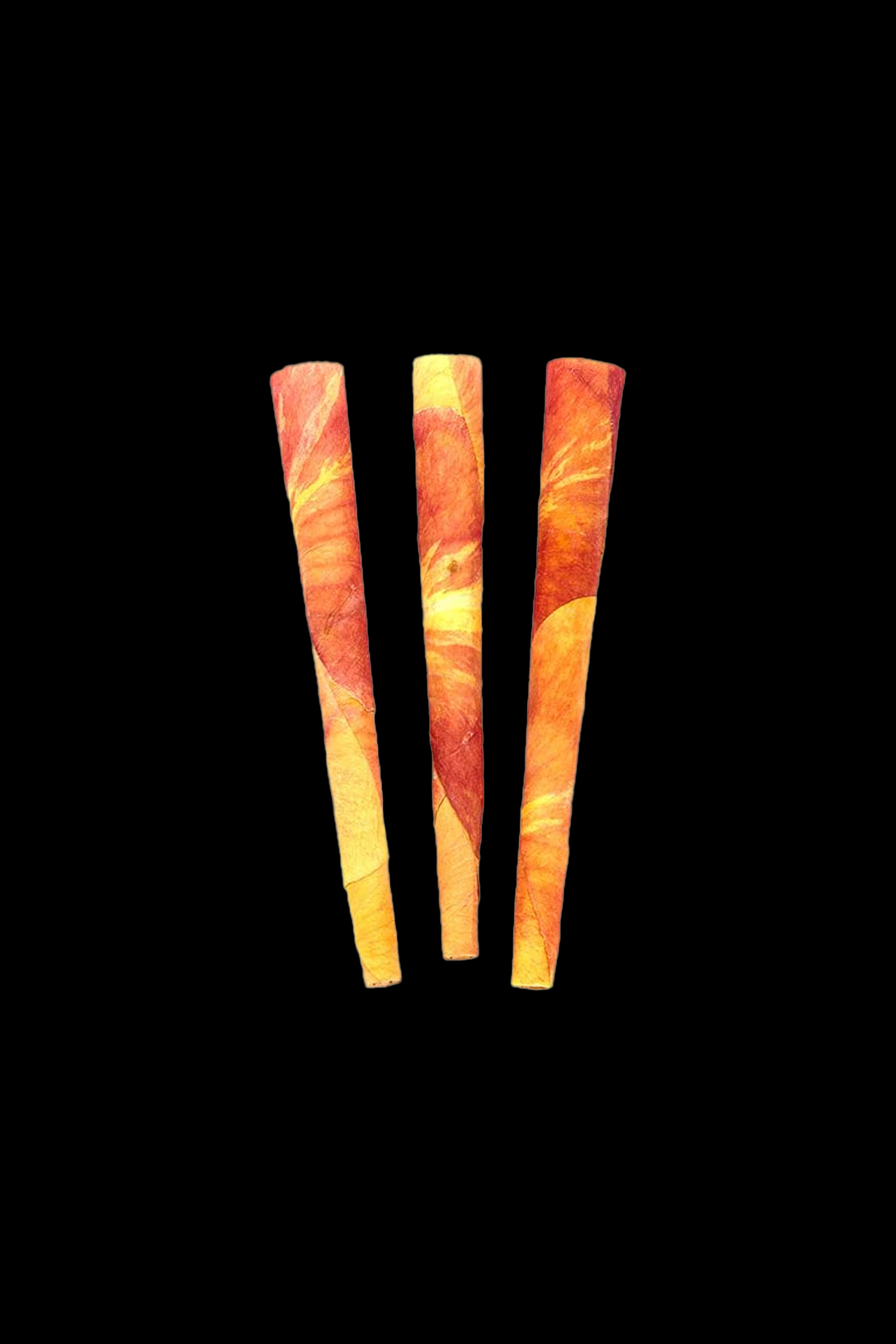 Four pre-rolled cannabis cones with orange and brown patterned papers against a black background.