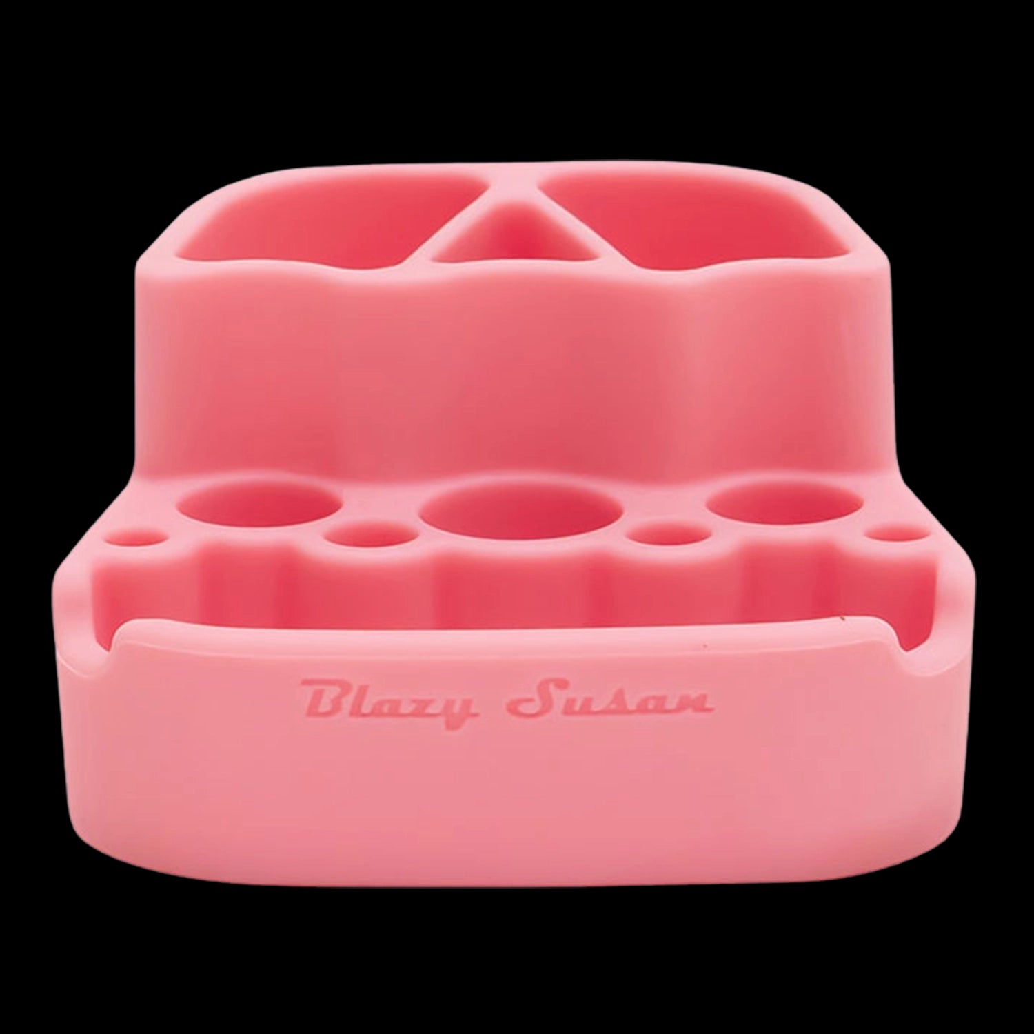 Front-facing close-up of the pink Blazy Susan Dab Station showing its molded silicone compartments and circular tool holes against black.