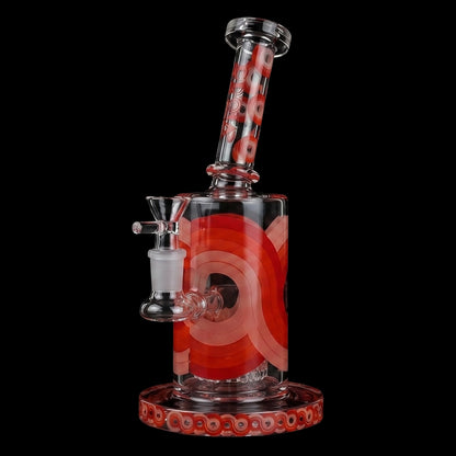 Angled close-up of the Croia Glass Retro Scientific Bong with Matrix Perc showing its clear glass neck and orange concentric ring designs on a black background