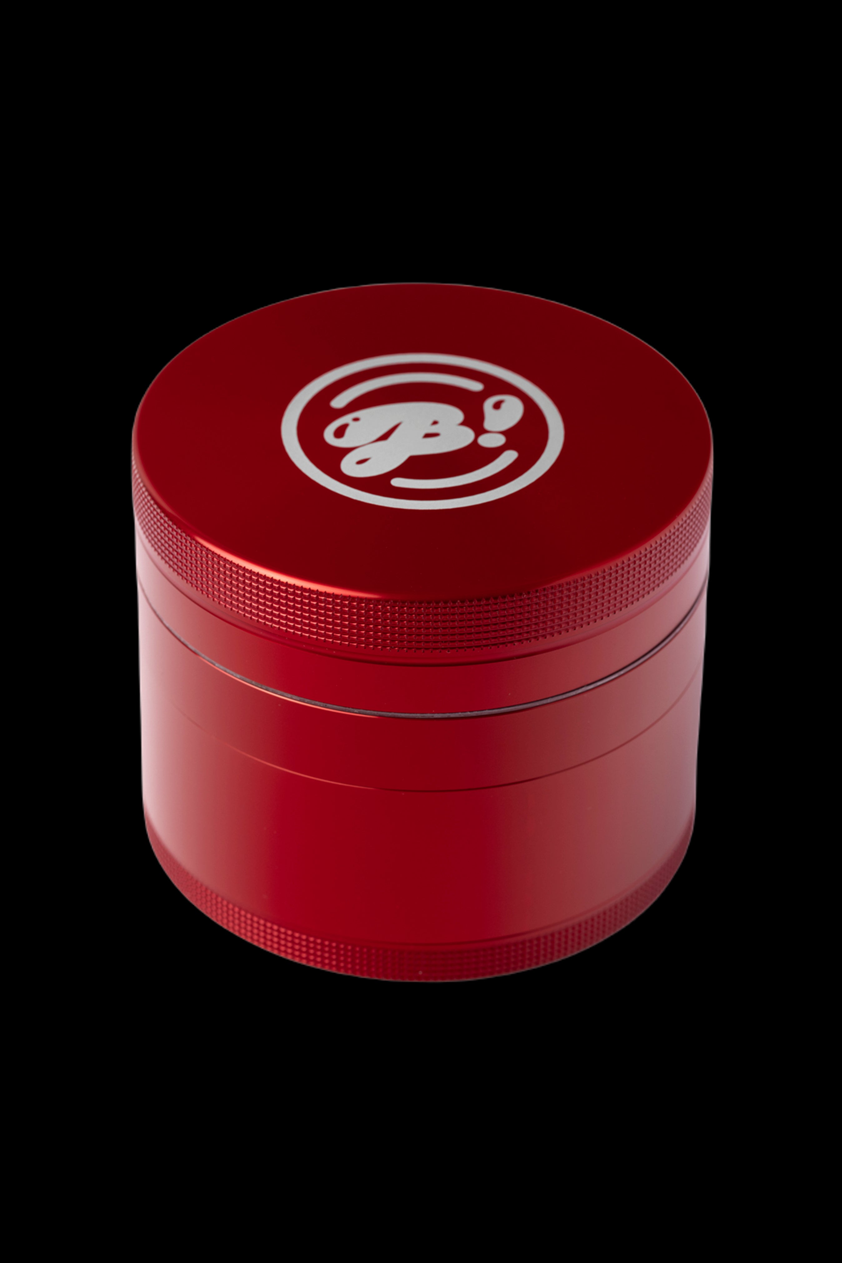 Red four-chamber grinder with a logo on top.