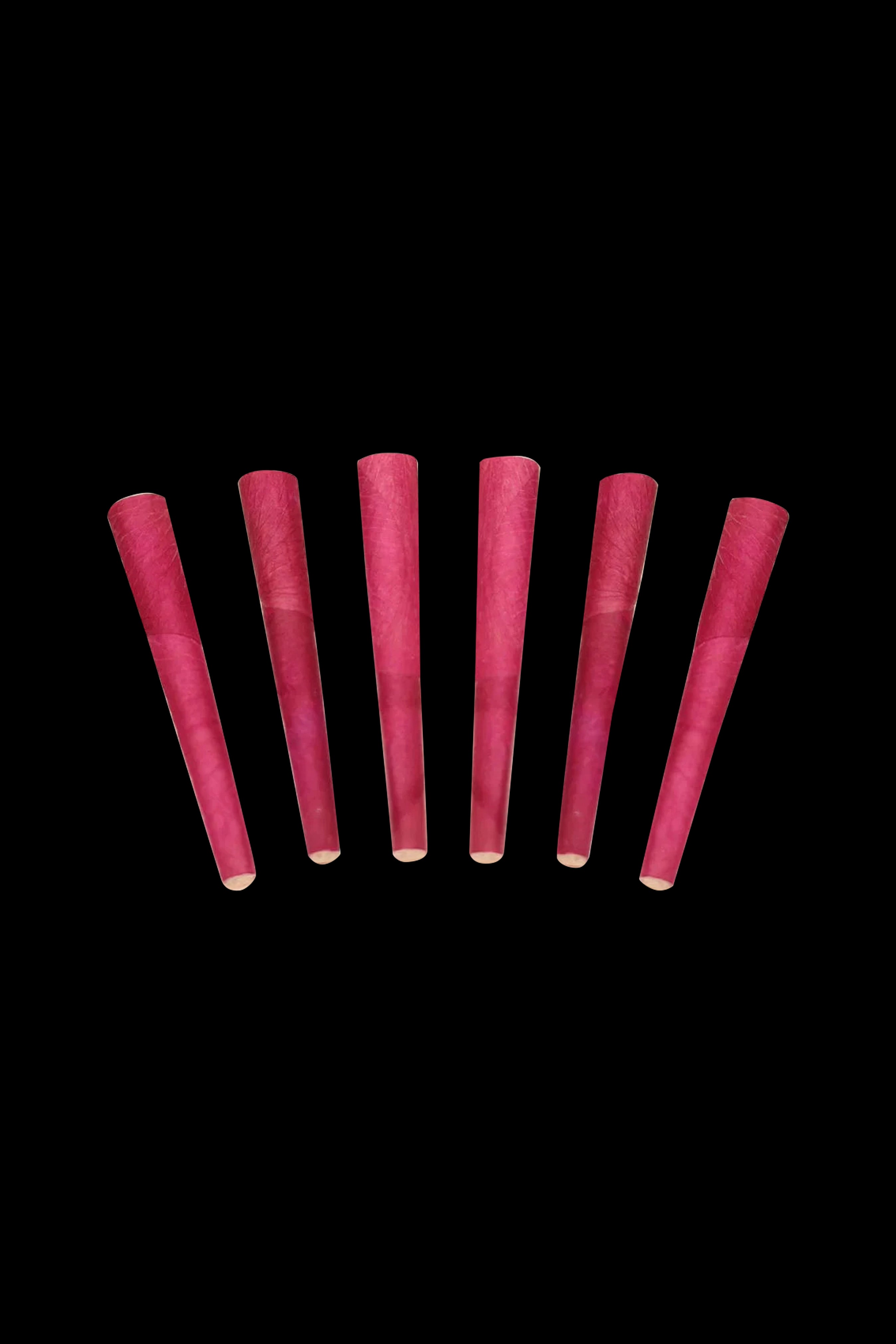 Seven pre-rolled, maroon-colored cannabis cones against a black background.