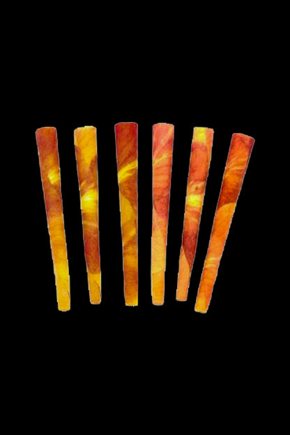 Seven pre-rolled cannabis cigarettes with a flame-like orange and red pattern against a black background.