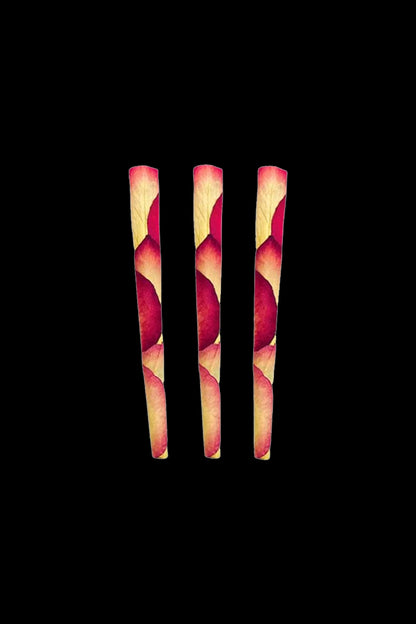 Four pre-rolled cannabis cones with a patterned, burgundy and gold design against a black background.