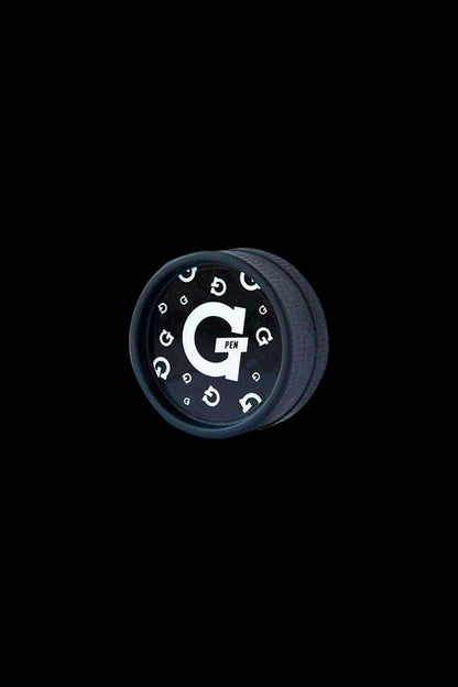Black cannabis concentrate container with white “G Pen” logo encircled by repeating “G” symbols.