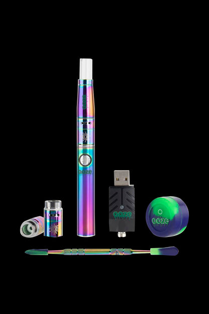 Iridescent cannabis oil vape pen kit with USB charger and applicator tips on a black background.