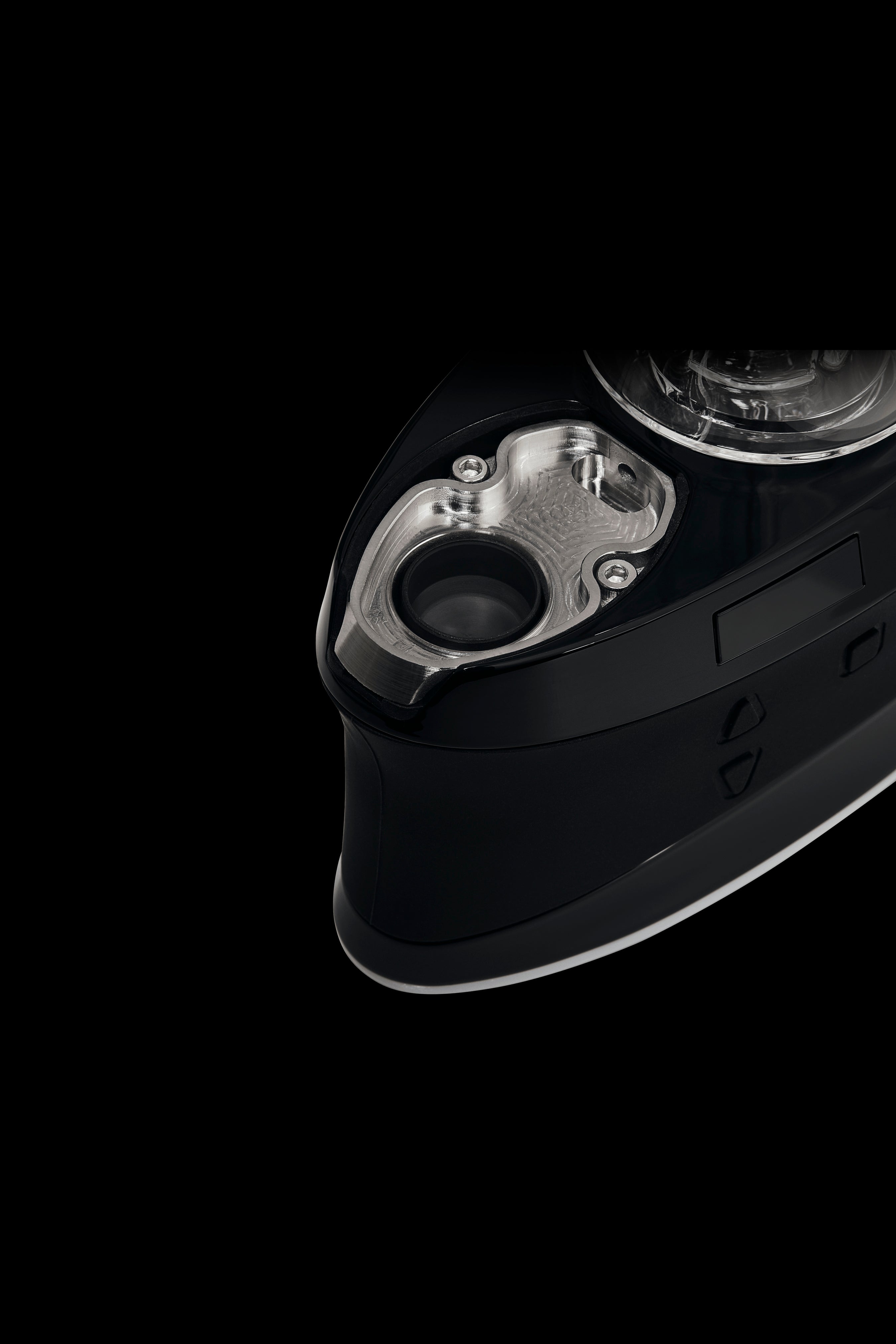 Close-up of a black cannabis dab rig with a clear glass water pipe attachment, isolated on a black background.