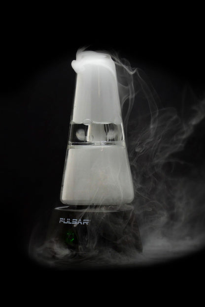 A vaporizing device emitting thick, white vapor against a dark background, displaying the brand name "Pulsar."
