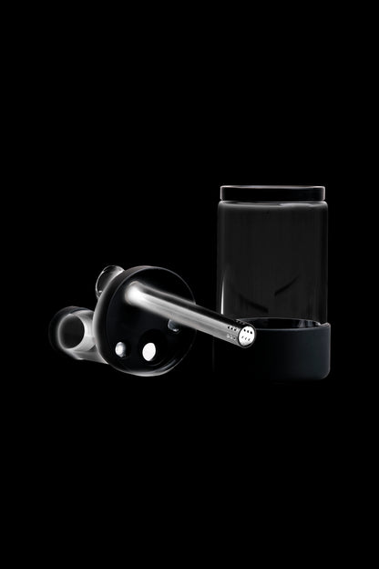 Black cannabis dab rig with glass carb cap and container.