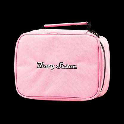 Front-facing close-up of a pink Blazy Susan Stash Bag with embroidered logo, top handle and visible side zipper against a black background