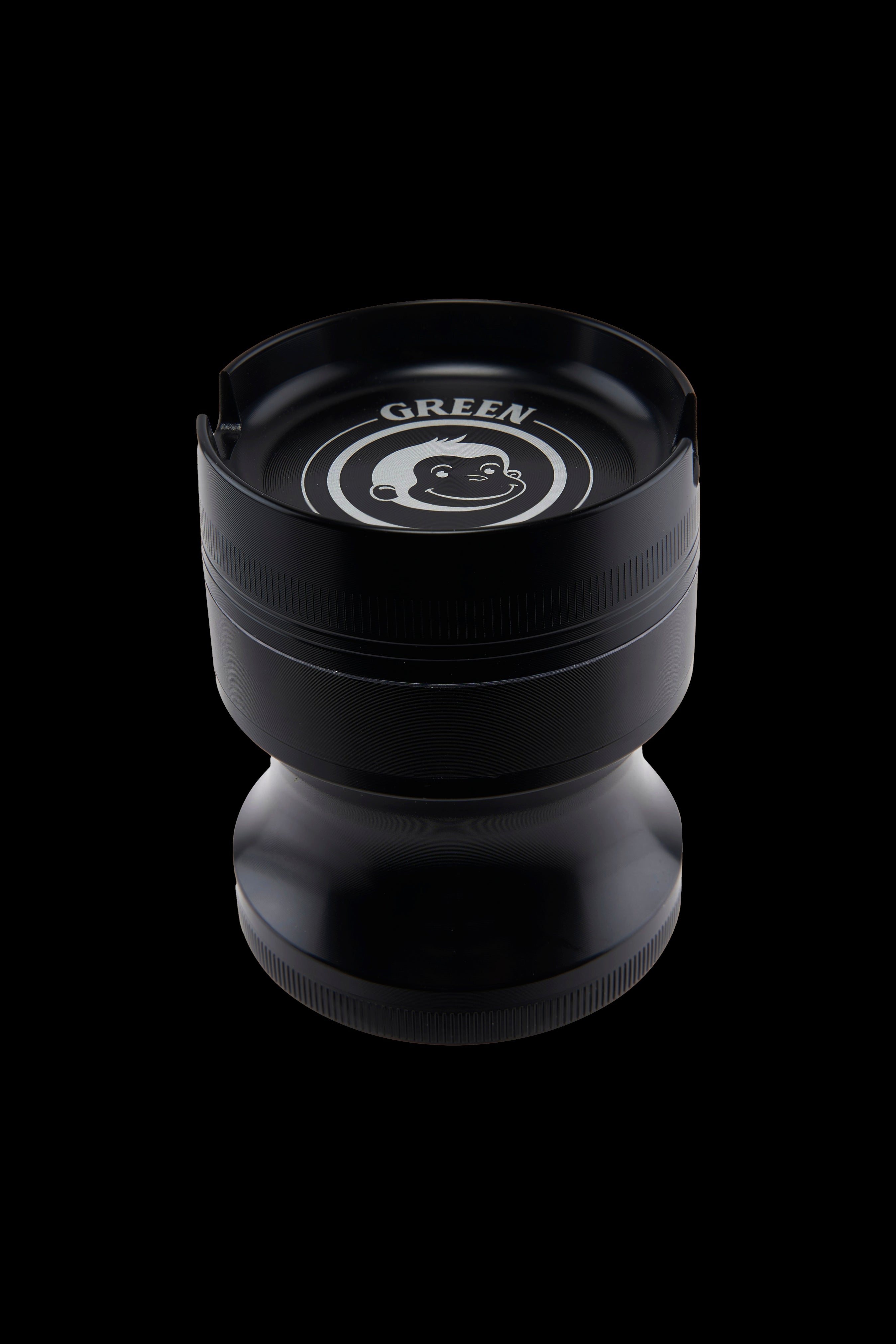 Top-down close-up of the Green Monkey Chacma Grinder with Ashtray showing the black lid, white monkey logo and stepped cylindrical body.