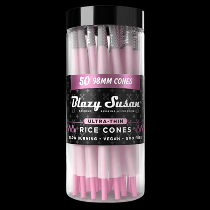 Centered front view of a clear jar of Blazy Susan Ultra Thin Rice Cones showing stacked pink cones and a black label on black background
