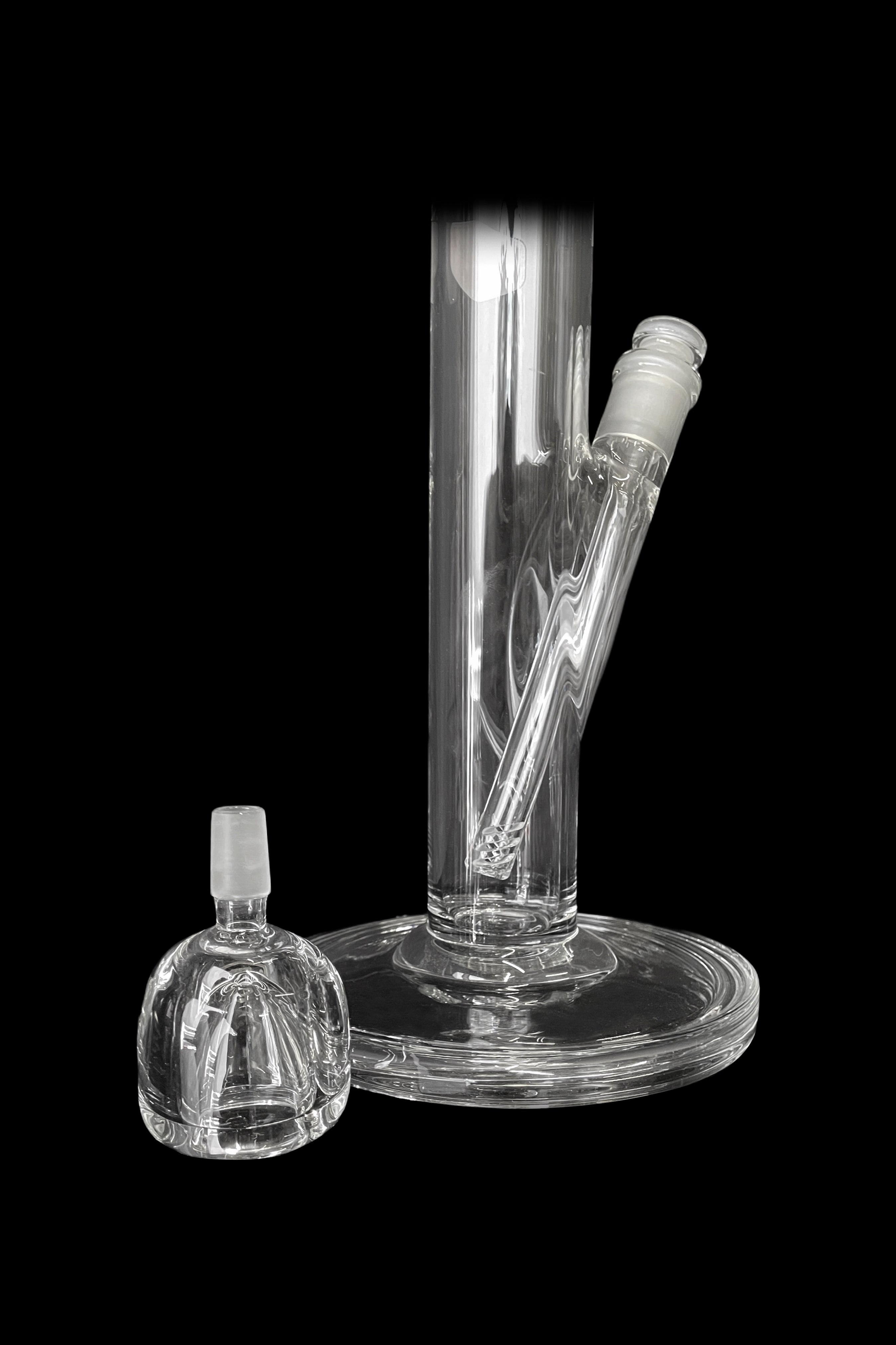 Clear glass bong and attachment on a black background.