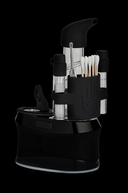 Black cannabis concentrate vaporizer with multiple dab containers and tools.