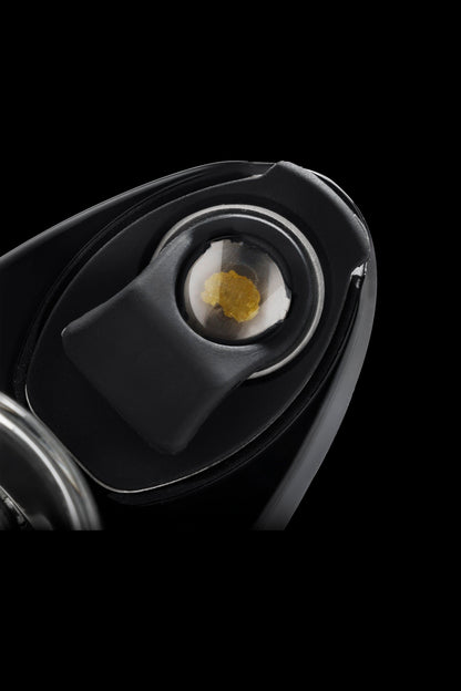 Close-up of a cannabis concentrate (“shatter”) inside a dab rig’s bowl.