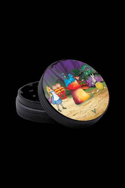 A black grinder with a colorful "Alice in Wonderland" themed lid depicting Alice, the Mad Hatter, and other characters around a large mushroom.