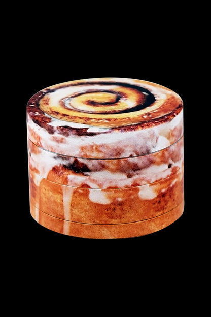 Cannabis grinder with a cinnamon roll pattern.