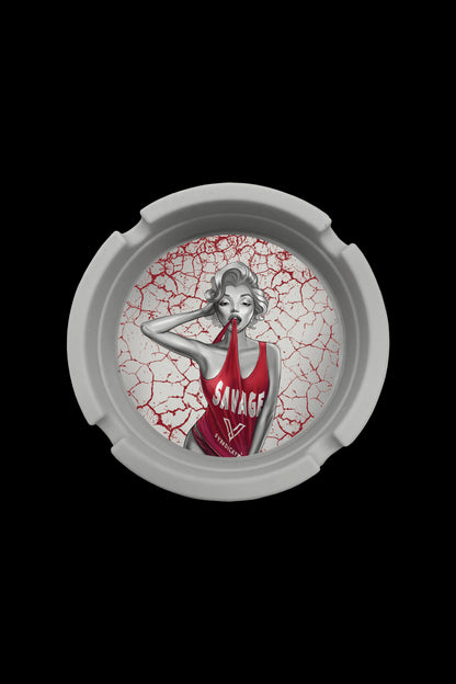 Round ashtray with cracked red design featuring a pin-up girl wearing a "Savage" jersey.
