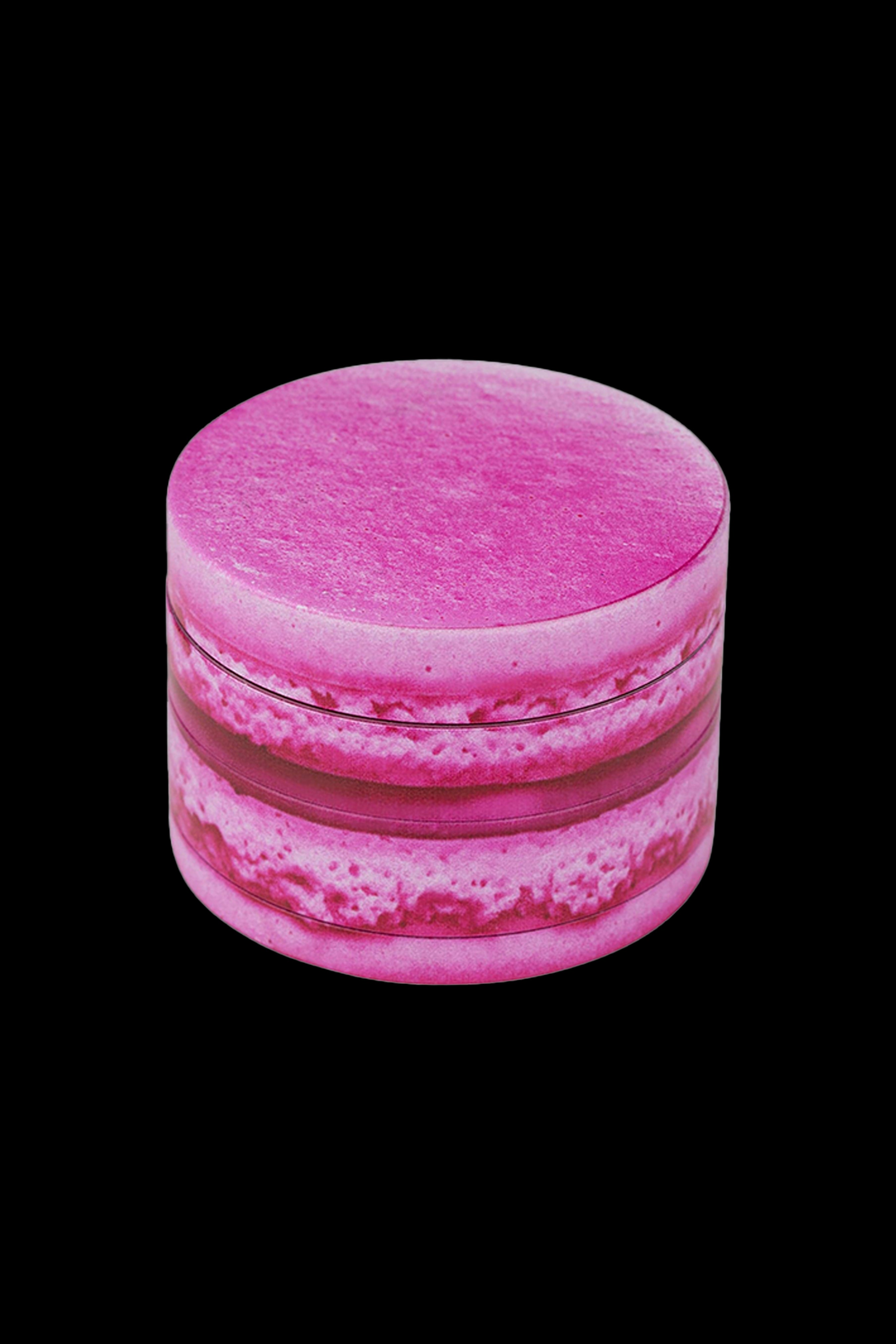 Pink cannabis grinder on a black background.