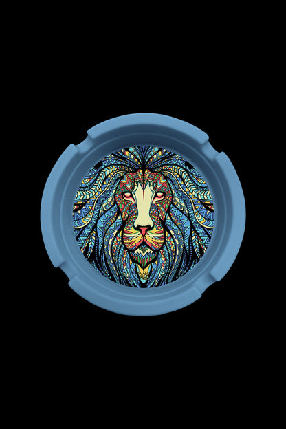 A circular, blue silicone container lid featuring an intricate, colorful lion's head design.