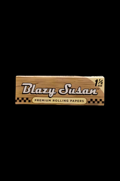 Pack of Blazy Susan 1 ¼ size premium rolling papers against a black background.