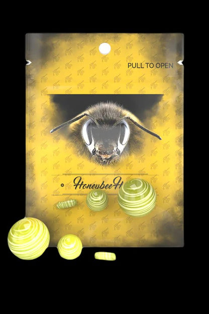 Packaging for “Honeybee” cannabis wax concentrate, featuring a close-up of a bee and scattered wax pieces.