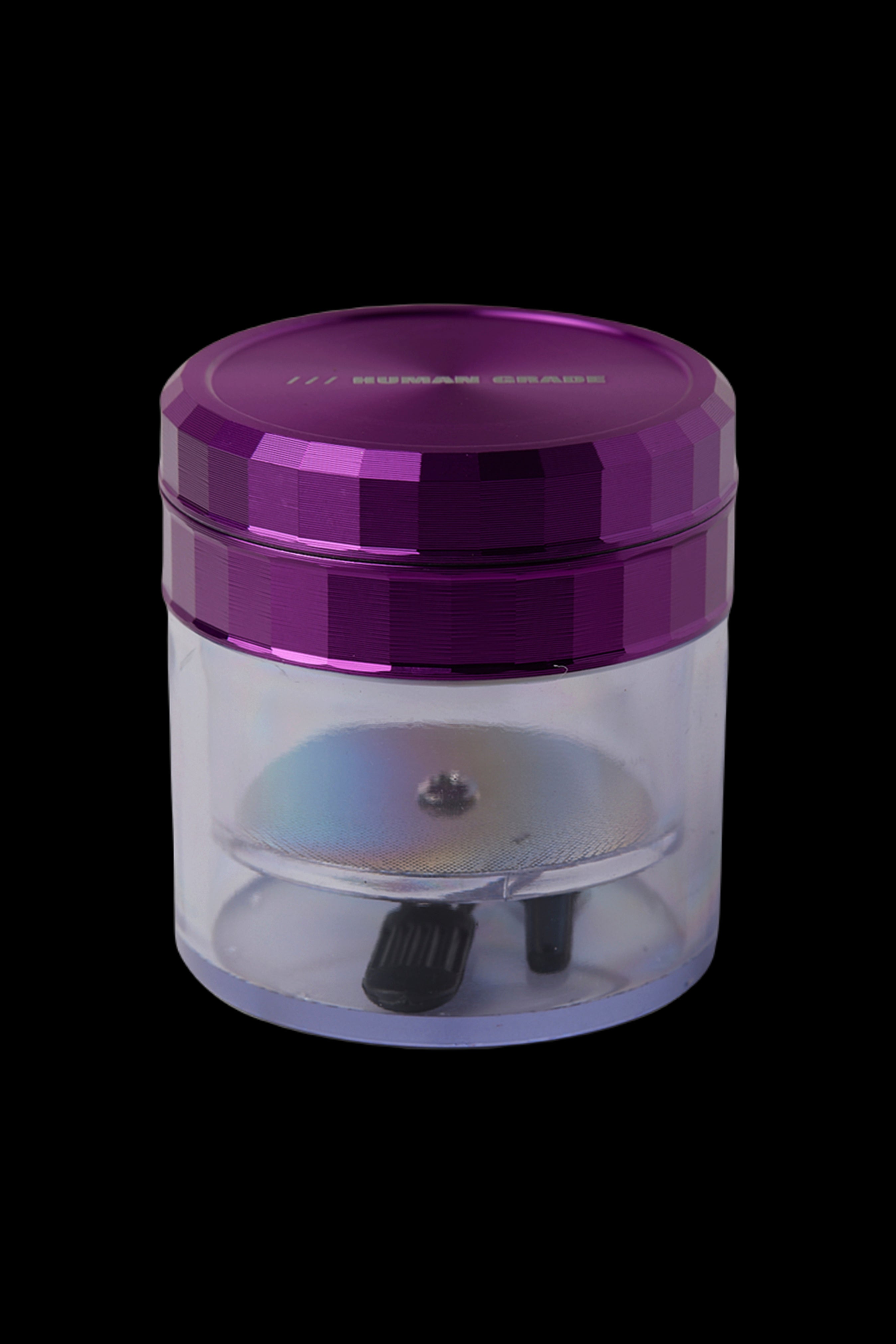 Purple and clear cannabis grinder isolated on a black background.